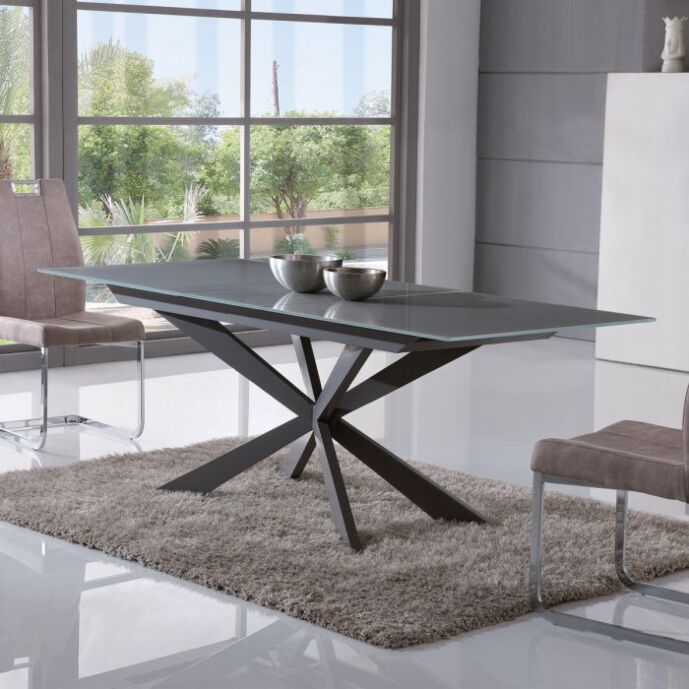 Tavolo di design allungabile con piano in vetro grigio e gambe in metallo